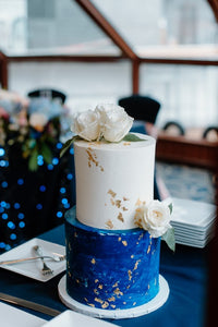 White, Navy Blue and Gold Wedding Cake with White Florals